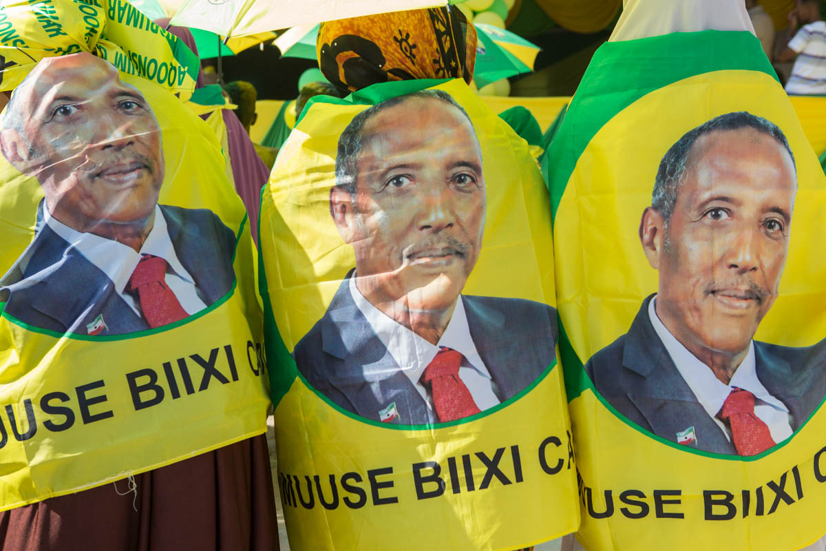 The face of presidential candidate, Muse Bihi Abdi, of the ruling Kulmiye party, features on women’s shawls at a rally in Hargeisa. Bihi is a former soldier who fought for the Somali National Movement against the Mogadishu government of Siyaad Barre. 'He has been a war veteran for the country and its people, therefore he can make the country safe in terms of security,' says Farah, a 45 year old Kulmiye supporter at a rally in Hargeisa. [Kate Stanworth/Saferworld/Al Jazeera]